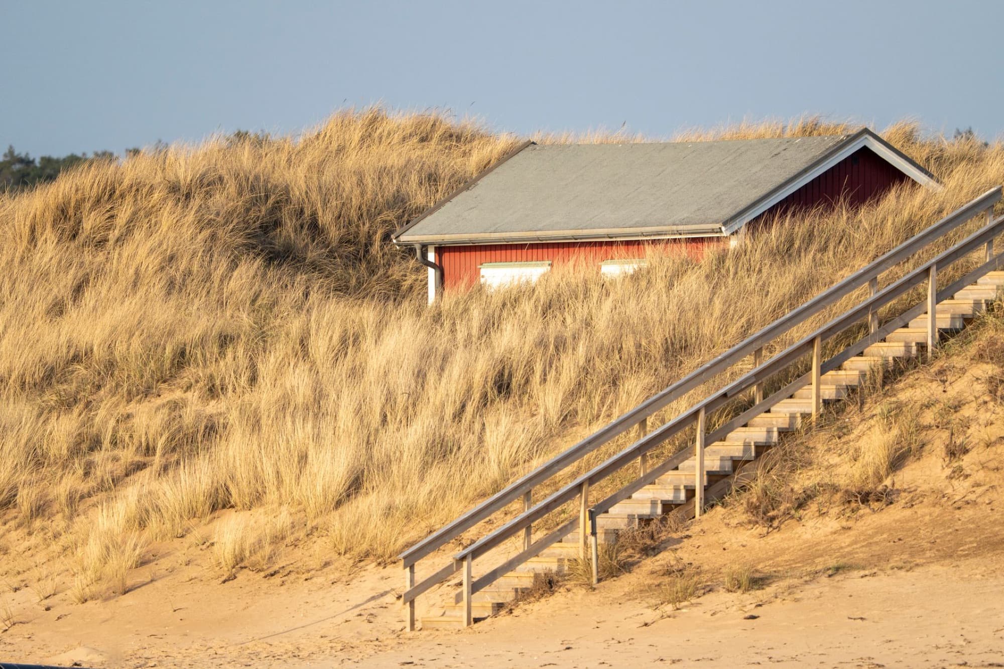 A beach house standing above the dune grass