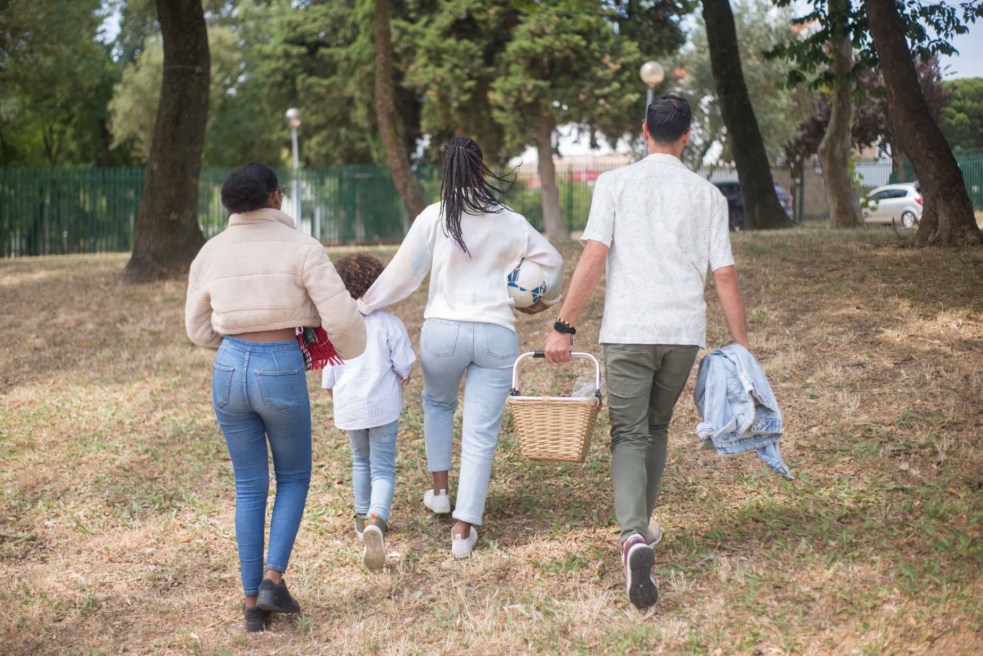 Parents and young children walking together outdoors