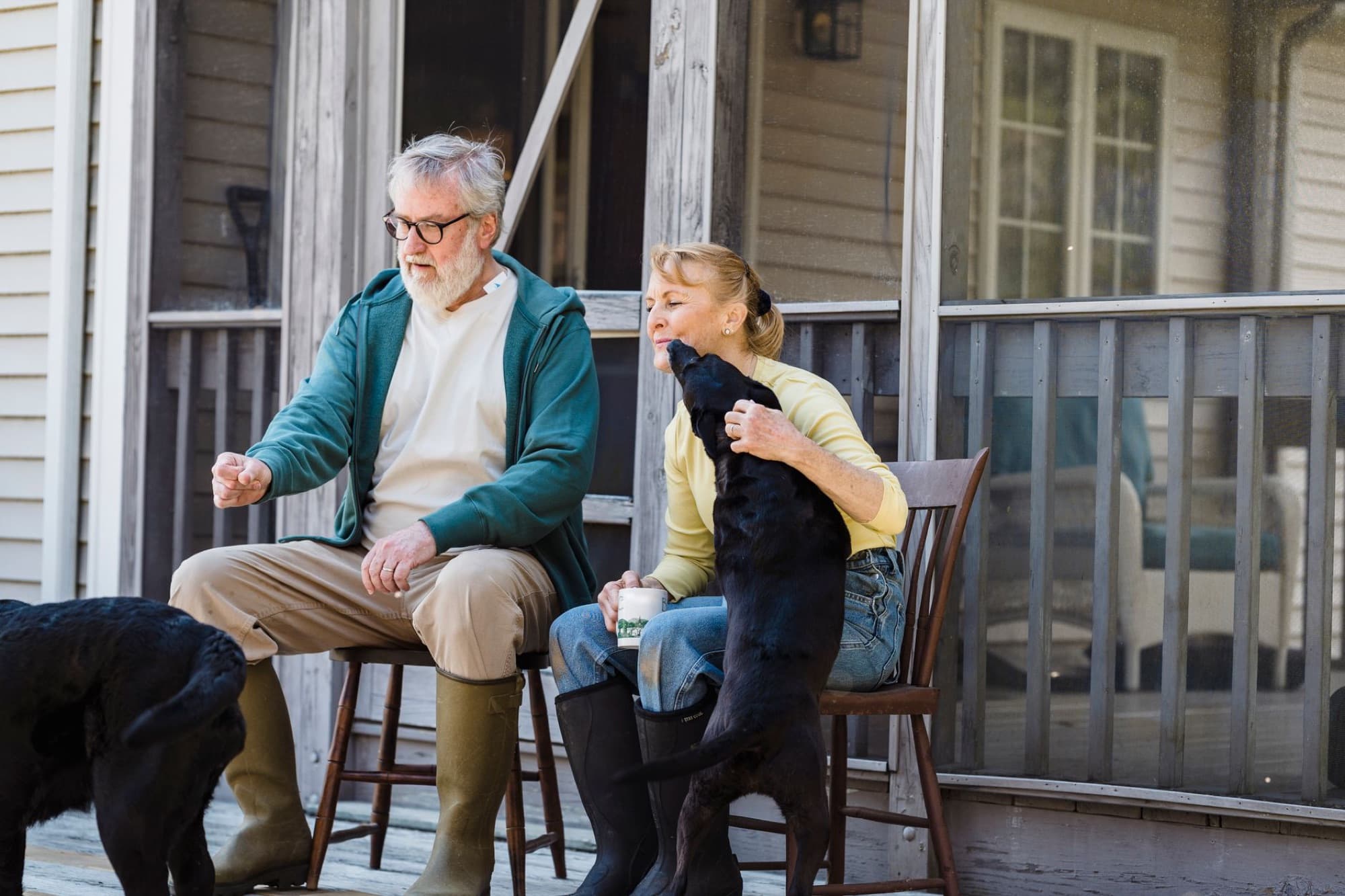 A retired couple having coffee on a porch