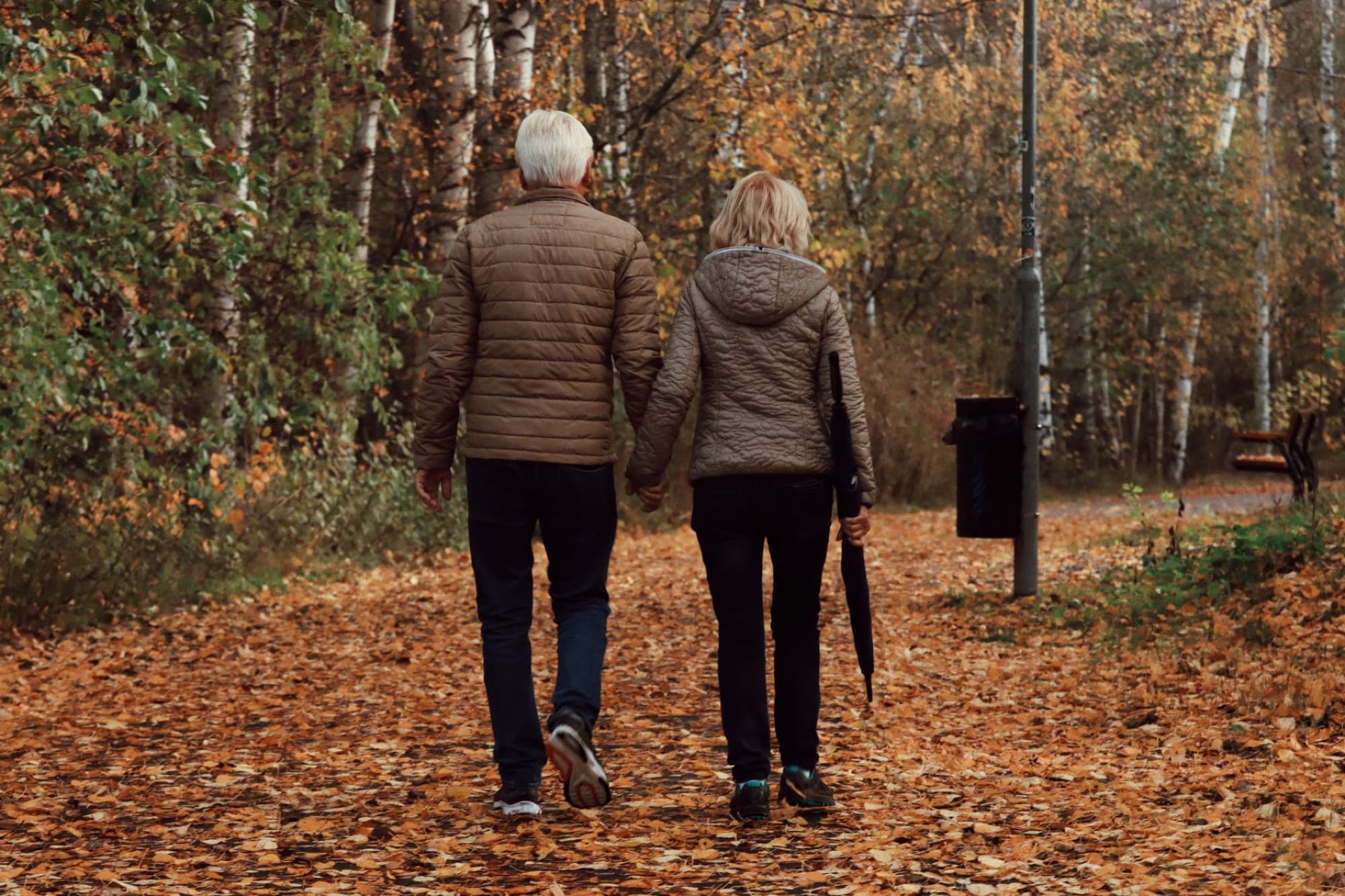 A couple walking together on a park path