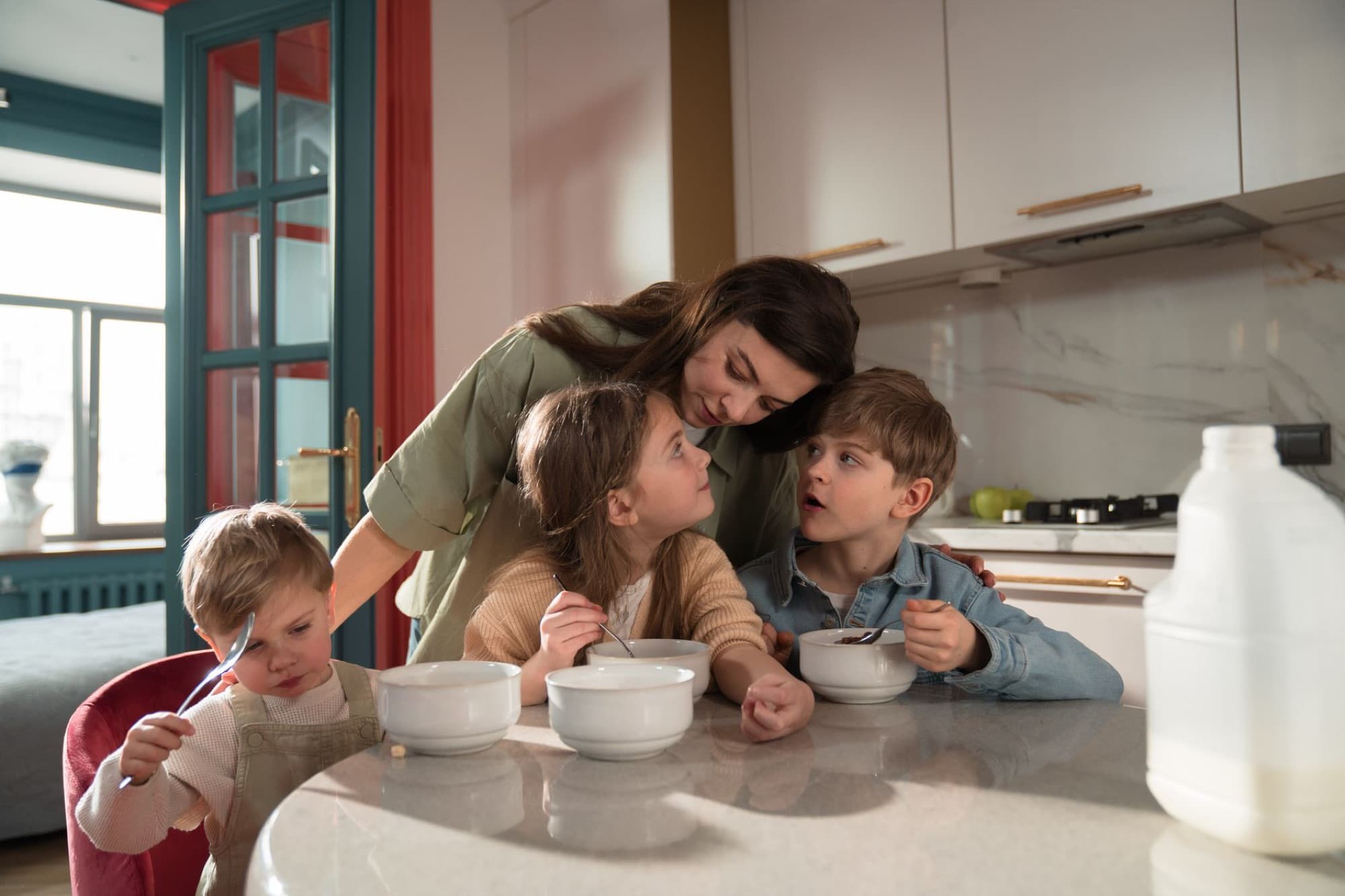 A family making breakfast together in a bright kitchen