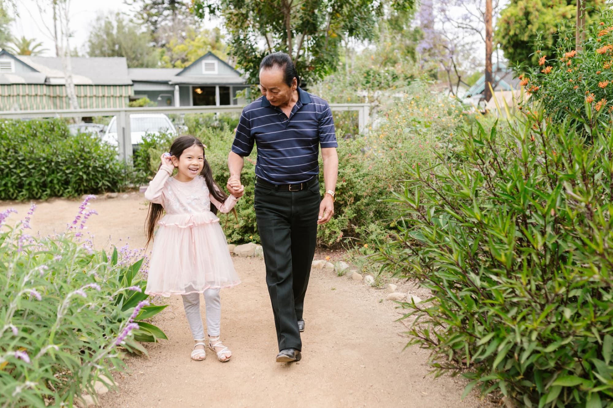 A grandparent and grandchild in a garden