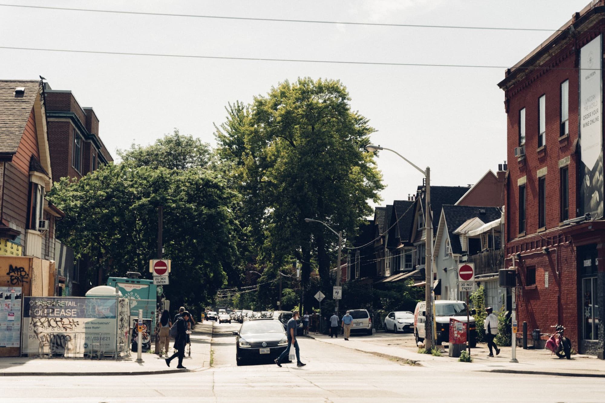 People going about an ordinary weekday on a neighborhood street