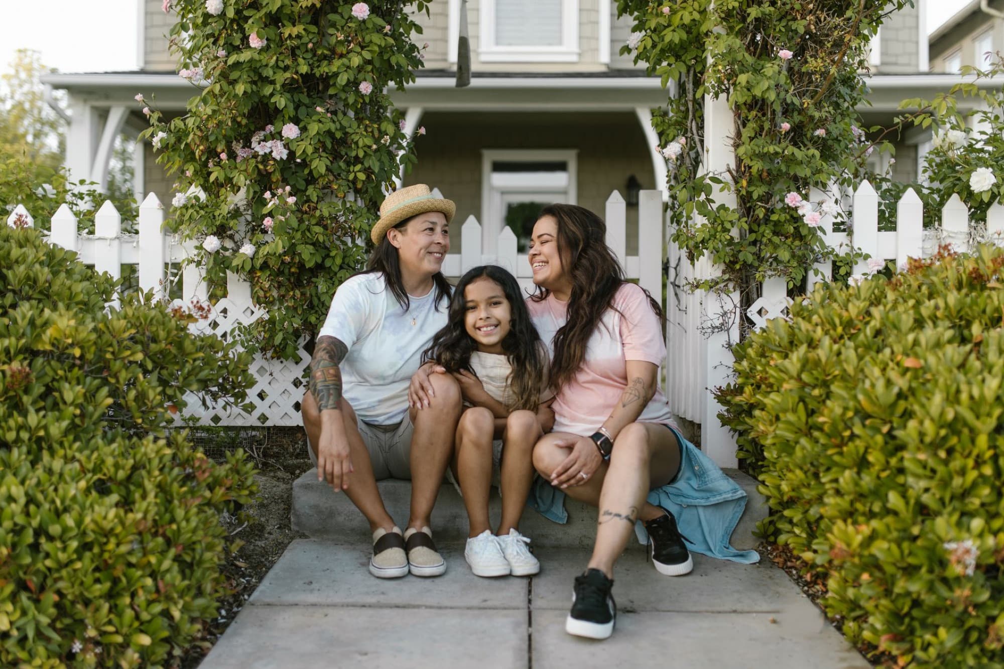 A family sitting together on their front steps